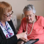 The Safe Steps app being used by two women in a care home