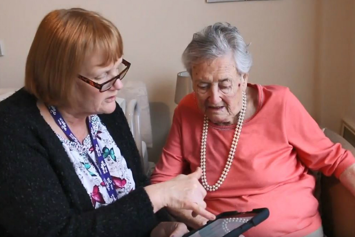 The Safe Steps app being used by two women in a care home