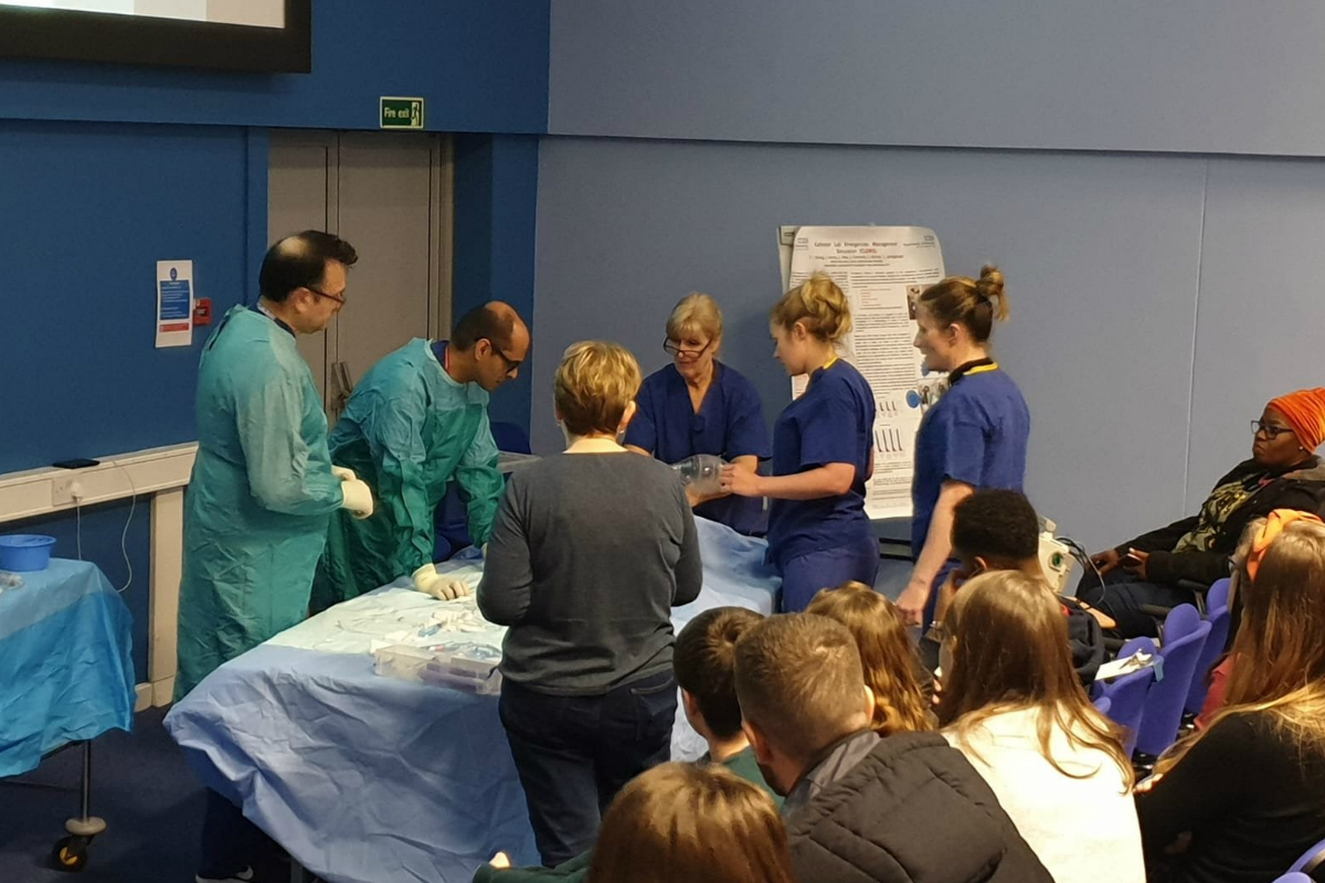 Staff in a lecture theatre watching a catheter demonstration at the Cardio Catheter Training day