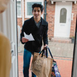 NHS Volunteer delivers food shopping to a home