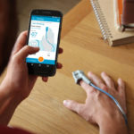 Feebris TechForce19 winner. A man checking his vital signs with a pulse oximeter and mobile phone app.