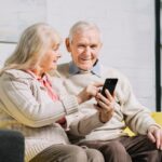 Elderly couple using app on mobile phone