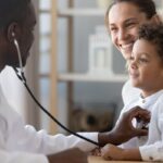 Child patient being monitored by doctor