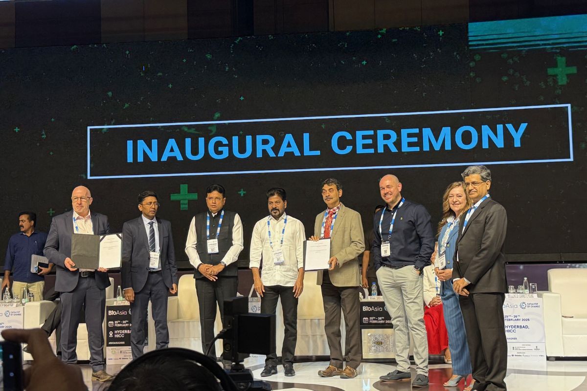 members of staff on stage with the memorandum